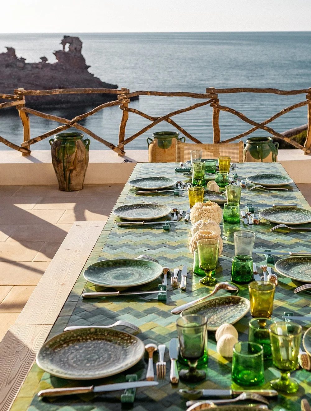 Green-tiled table on a terrace by the sea